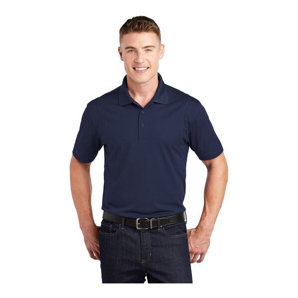 A man wearing a Sport-Tek True Navy short sleeve polo shirt.