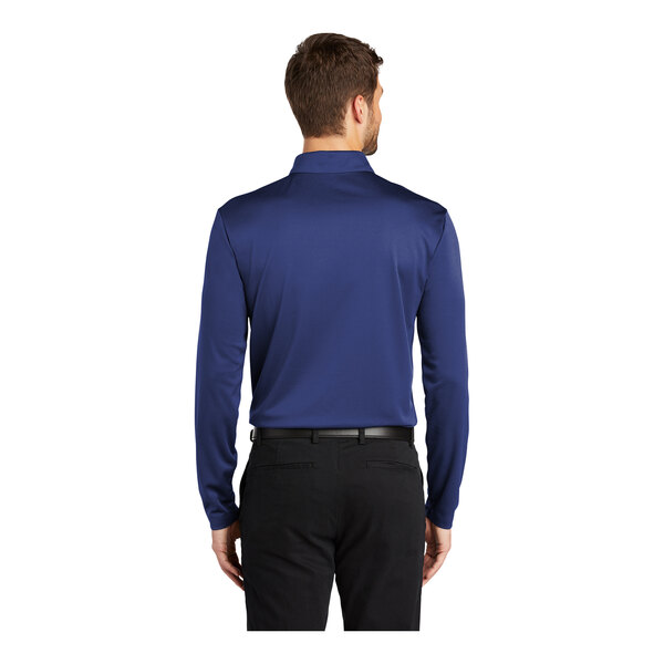 A man wearing a royal blue Port Authority long sleeve polo shirt.