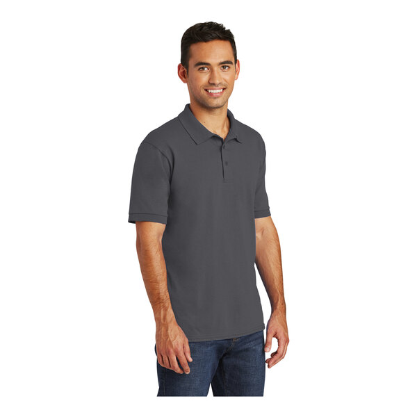 A man wearing a charcoal Port & Company short sleeve polo shirt.