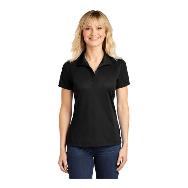 A woman wearing a black Sport-Tek short sleeve polo shirt.