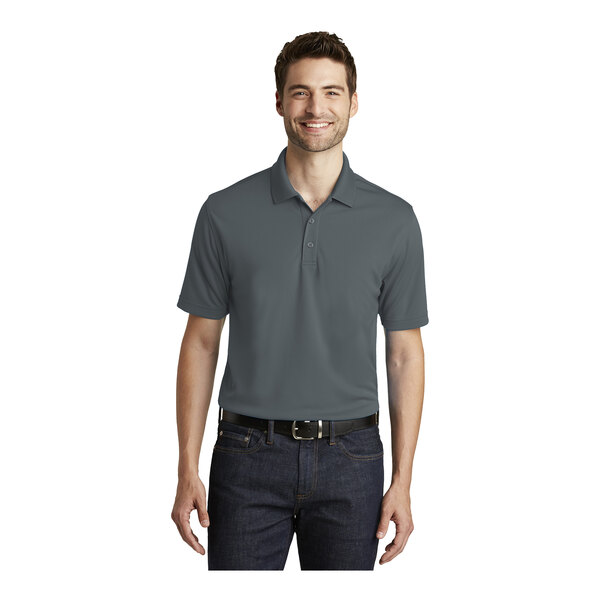 A man wearing a graphite Port Authority Dry Zone performance polo shirt.