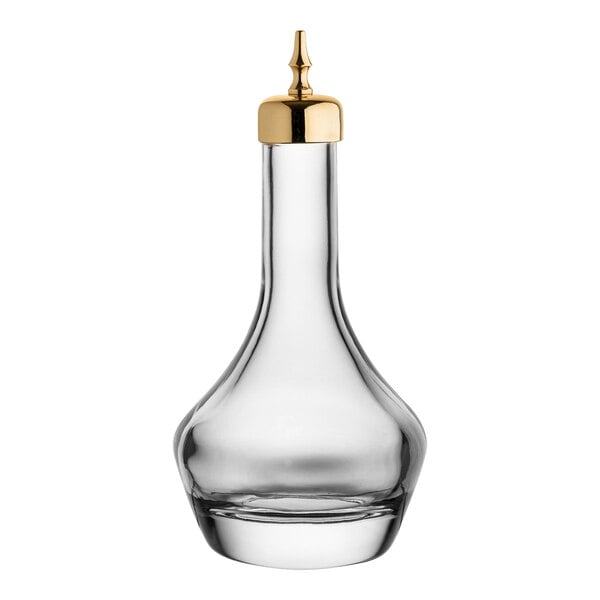 A clear glass Utopia bitters bottle with a gold dasher spout.