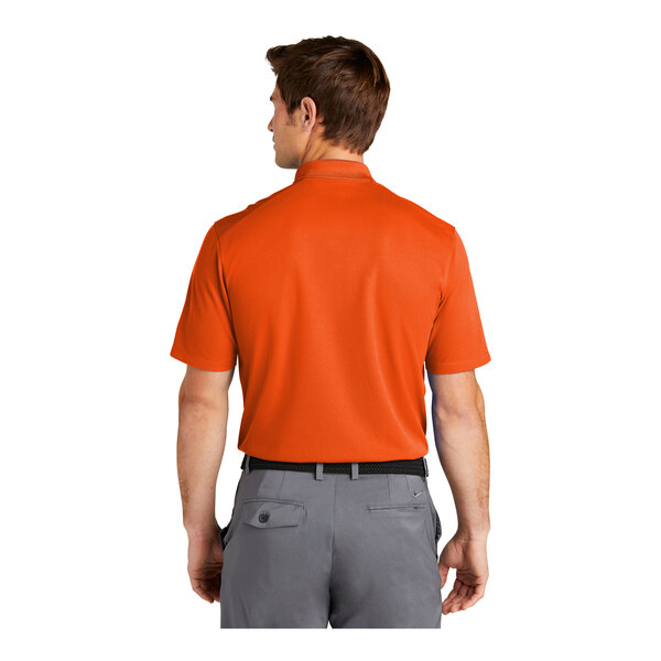 A man wearing a Nike Brilliant Orange polo shirt.