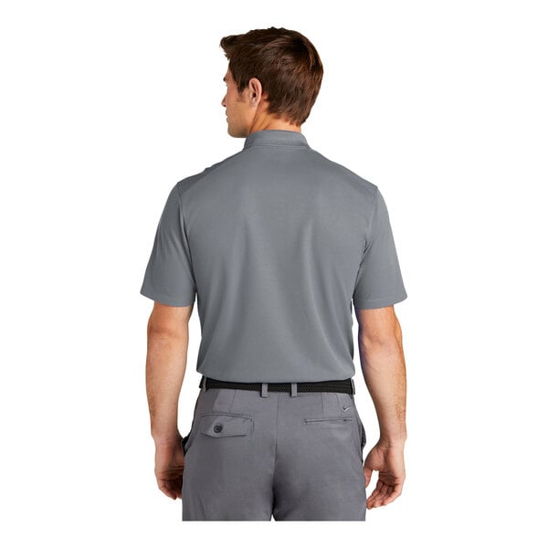 A man wearing a Nike Dri-Fit grey polo shirt.