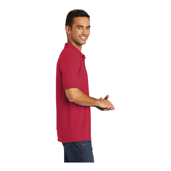 A man in a red Port & Company polo shirt.