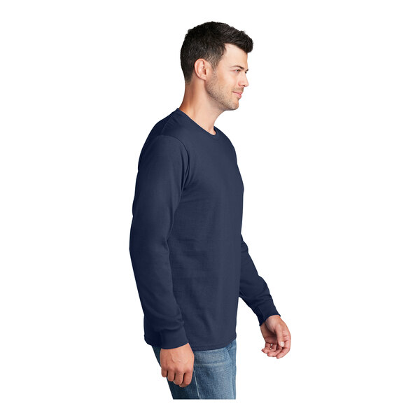 A man wearing a navy Port & Company long sleeve t-shirt.