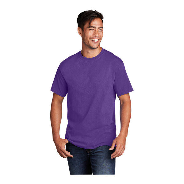 A man wearing a Port & Company team purple short sleeve t-shirt.