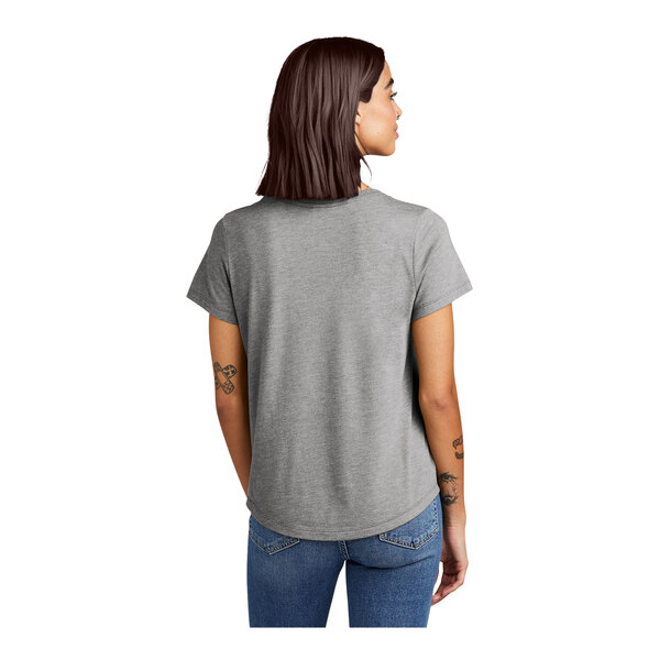 A woman wearing a grey AllMade short sleeve t-shirt.