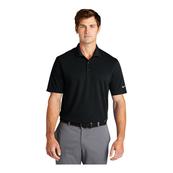 A man wearing a black Nike Dri-Fit polo shirt.