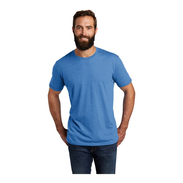 A man wearing an azure blue AllMade short sleeve t-shirt.