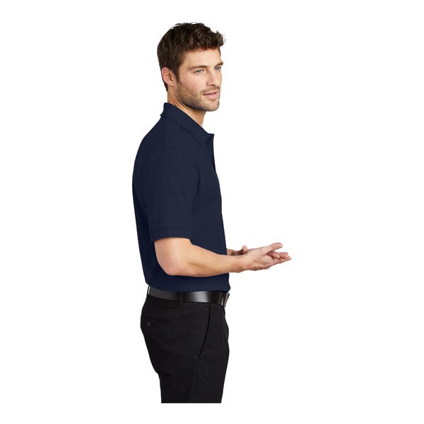 A man wearing a navy Port Authority® silk touch polo shirt.