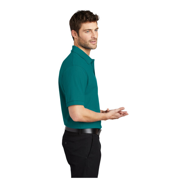 A man wearing a teal green Port Authority® Silk Touch™ Pique Polo Shirt.