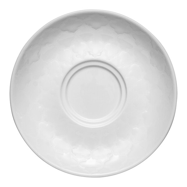 A white Libbey porcelain saucer with a circular design.