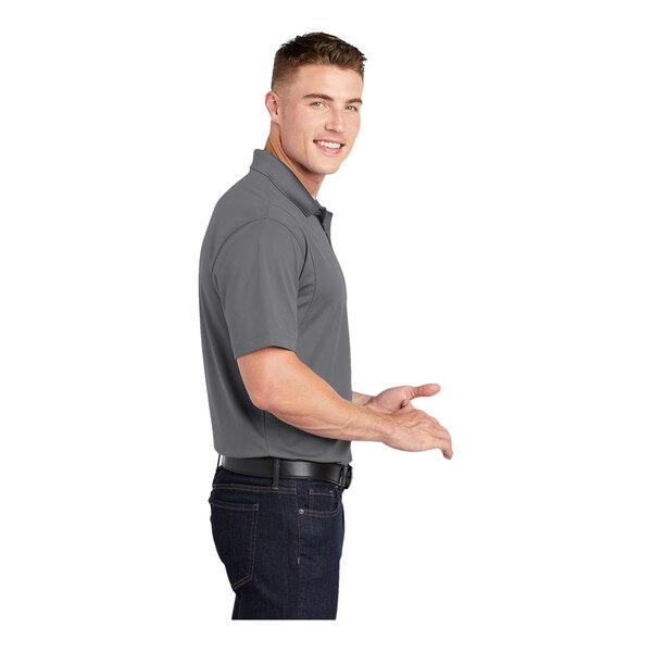 A man wearing a gray Sport-Tek concrete short sleeve polo.