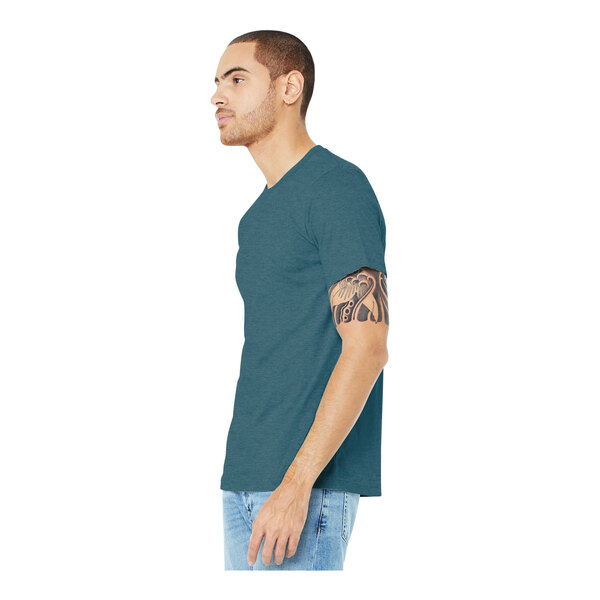 A man wearing a Bella + Canvas heather slate short sleeve tee shirt.