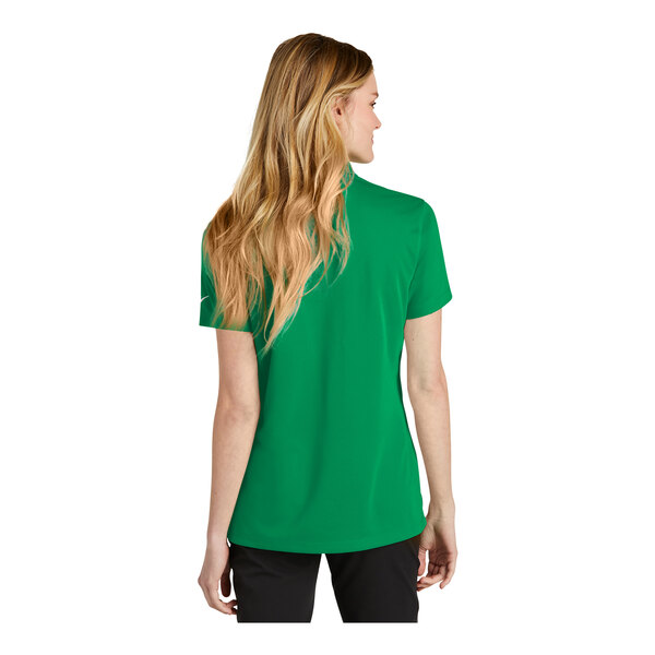 A woman wearing a green Nike polo shirt.