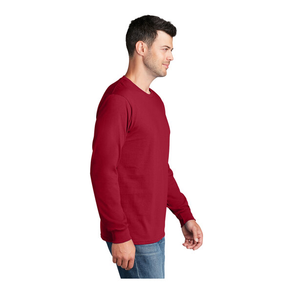 A man wearing a Port & Company red long sleeve T-shirt.