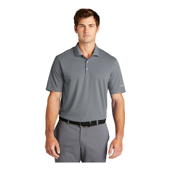 A man wearing a grey Nike Dri-Fit polo shirt with a collar.
