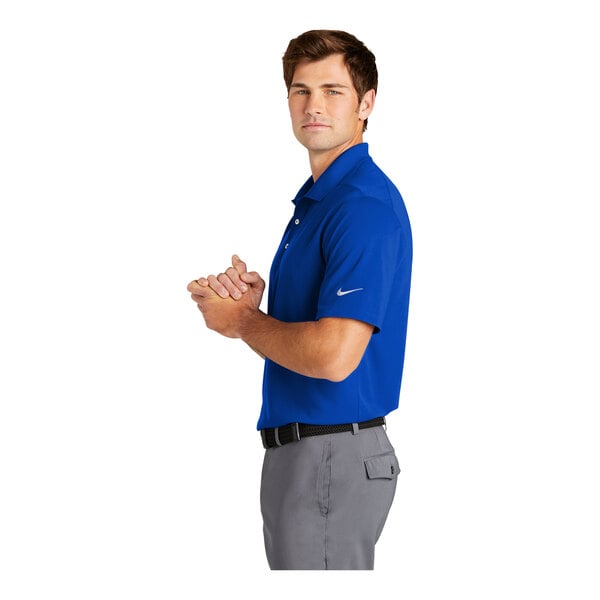 A man wearing a Nike Dri-Fit game royal blue polo shirt.