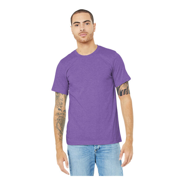 A man wearing a Bella + Canvas heather team purple t-shirt.