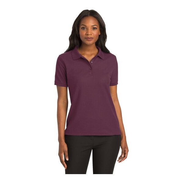 A woman wearing a maroon Port Authority polo shirt.