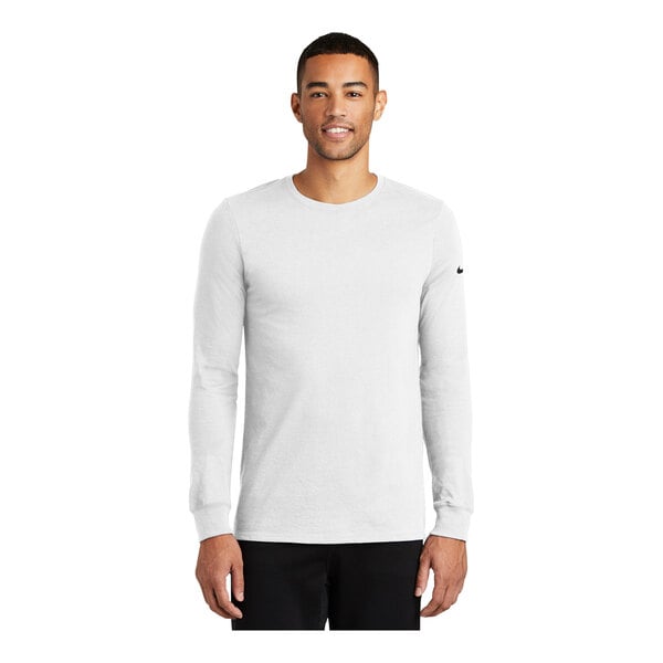 A man wearing a white Nike Dri-FIT long sleeve t-shirt.