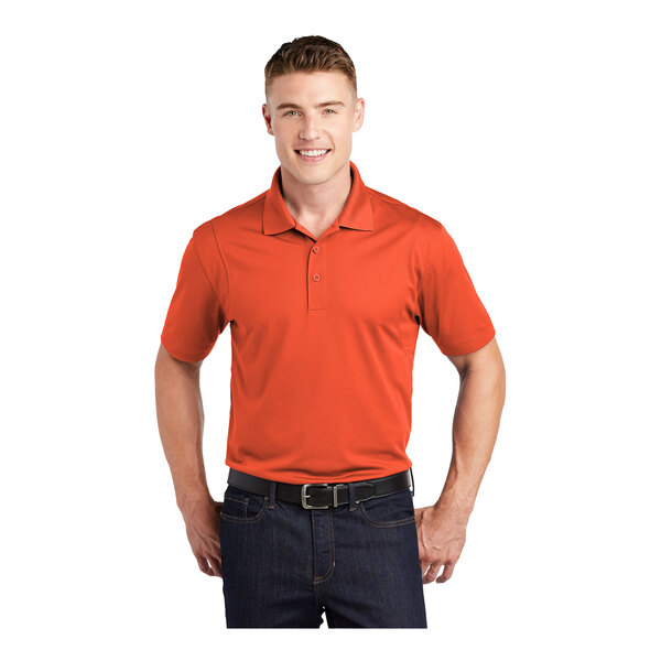 A man wearing a deep orange Sport-Tek moisture-wicking polo shirt.