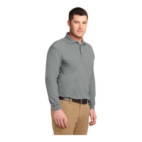 A man wearing a Port Authority Cool Gray long sleeve polo shirt.