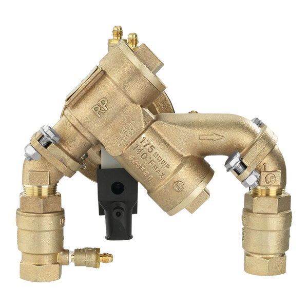 A gold metal pipe with black and silver fittings connected to a Watts LF825YA Reduced Pressure Zone Assembly.