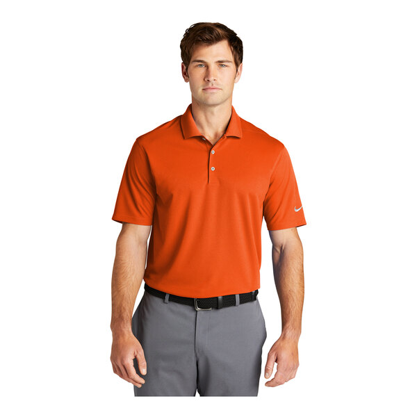 A man wearing a Nike Dri-Fit orange polo shirt.