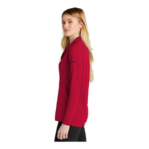 A woman wearing a red Nike Dri-Fit long sleeve polo shirt.