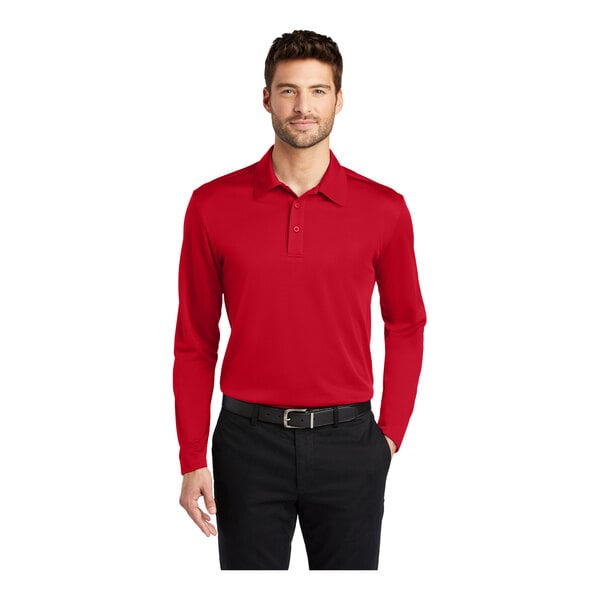 A man wearing a red Port Authority long sleeve polo shirt.