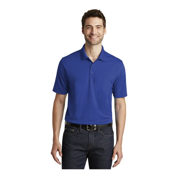 A man wearing a Port Authority True Royal short sleeve polo shirt.