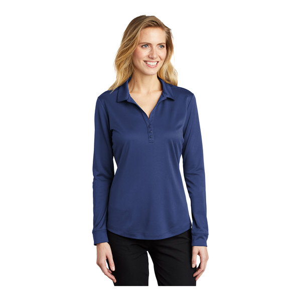 A woman wearing a Port Authority Royal Blue long sleeve polo shirt.