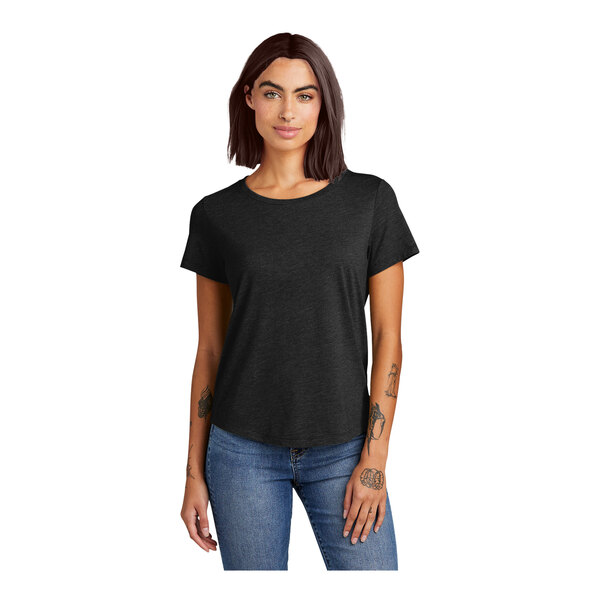 A woman wearing a black AllMade tri-blend T-shirt with a scoop neck.