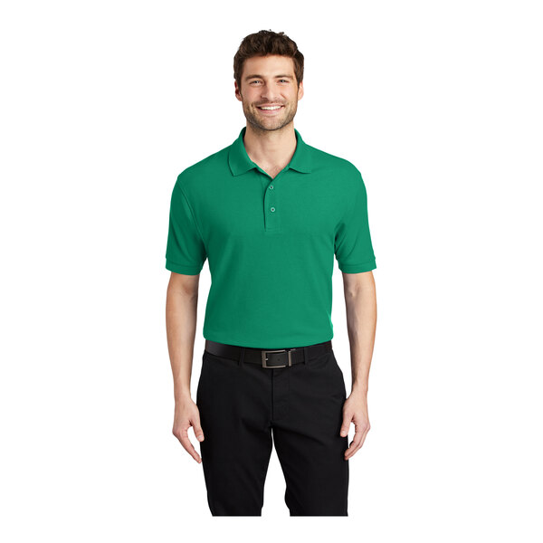 A man wearing a Port Authority® Kelly Green Silk Touch® Pique Polo shirt.