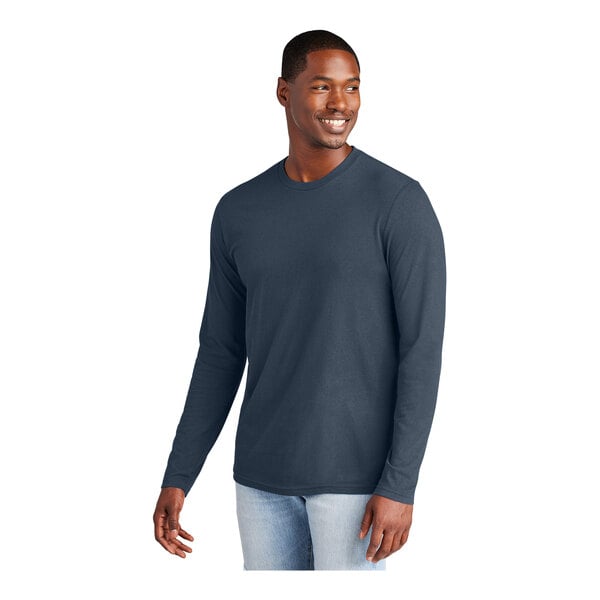 A man wearing a District New Navy long sleeve T-shirt.