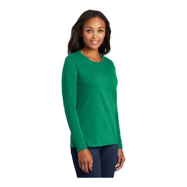 A woman wearing a Port & Company Kelly green long sleeve t-shirt.