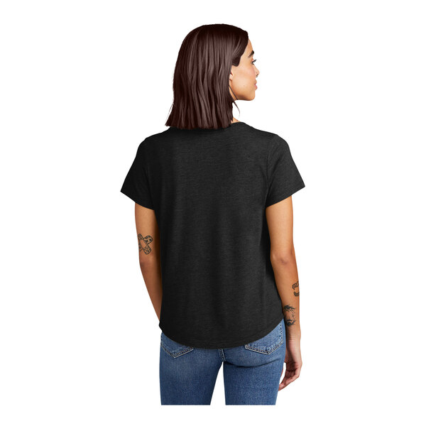 A woman wearing a black AllMade space black tee shirt.