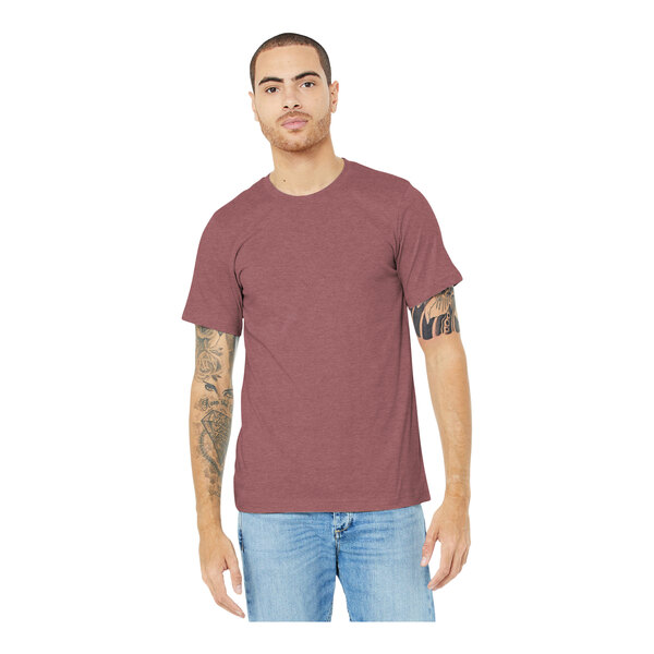A man wearing a Heather Mauve Bella + Canvas t-shirt and jeans.