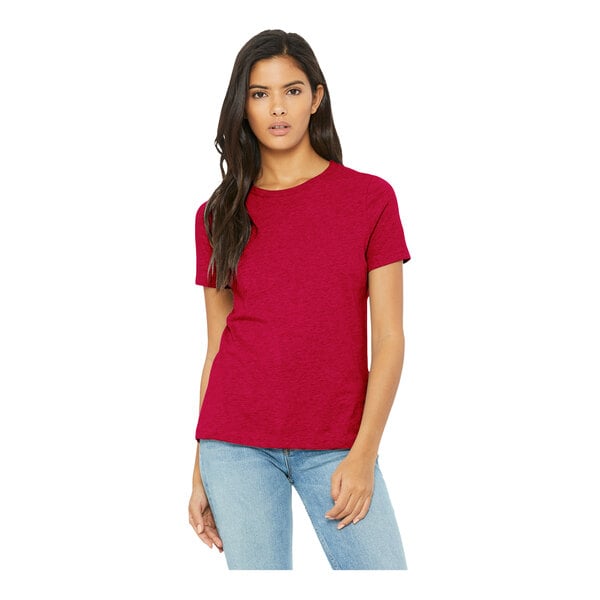 A woman wearing a heather red Bella + Canvas customizable crew neck t-shirt.