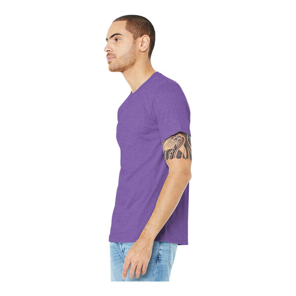 A man wearing a Bella + Canvas Heather Team Purple T-shirt.