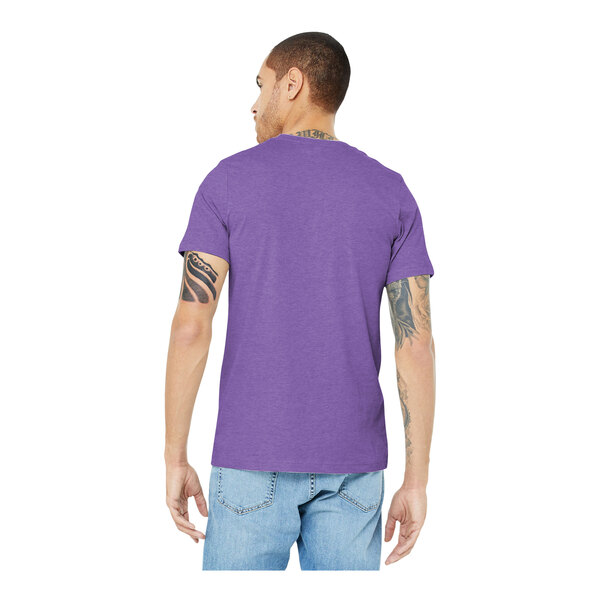 A man wearing a Bella+Canvas heather team purple short sleeve t-shirt.