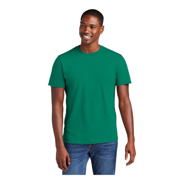 A man wearing a District® jewel green combed cotton T-shirt.