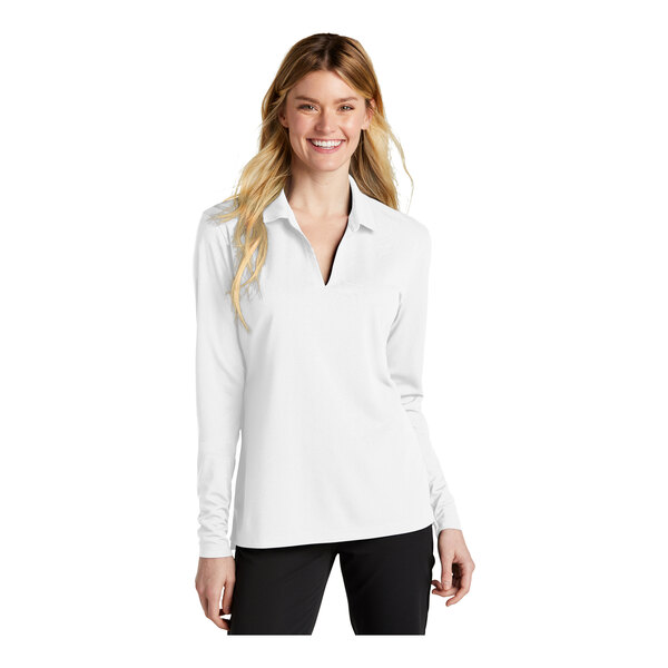 A woman wearing a white Nike long sleeve polo shirt with black trim.