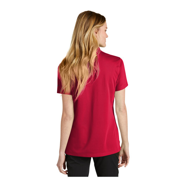 A woman wearing a red Nike polo shirt.