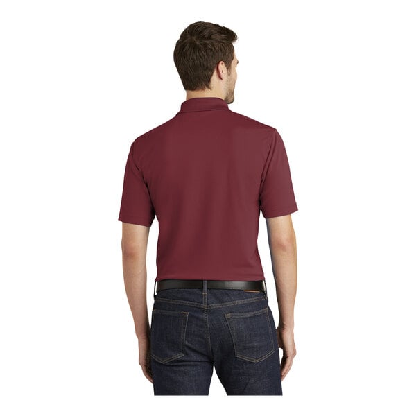 A man wearing a maroon Port Authority Dry Zone polo shirt.