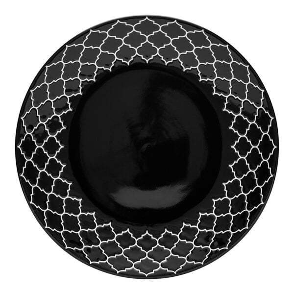 A black porcelain plate with white embossing in a geometric design.