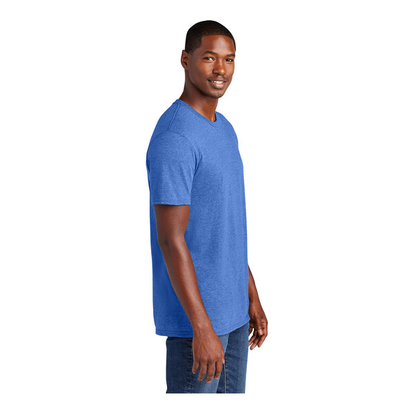 A man wearing a District Heathered Royal blue T-shirt smiling.