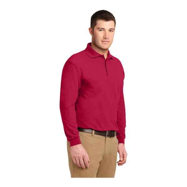 A man wearing a red Port Authority® long sleeve polo shirt.